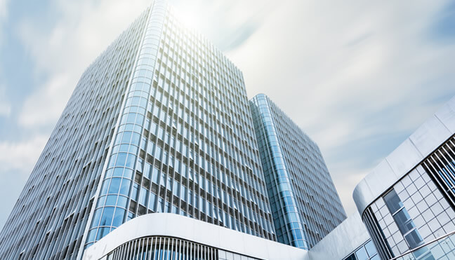 view of two tall skyscrapers from below